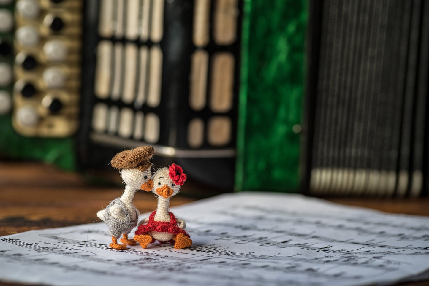 Miniature crochet geese — boy in cap and girl in red dress
