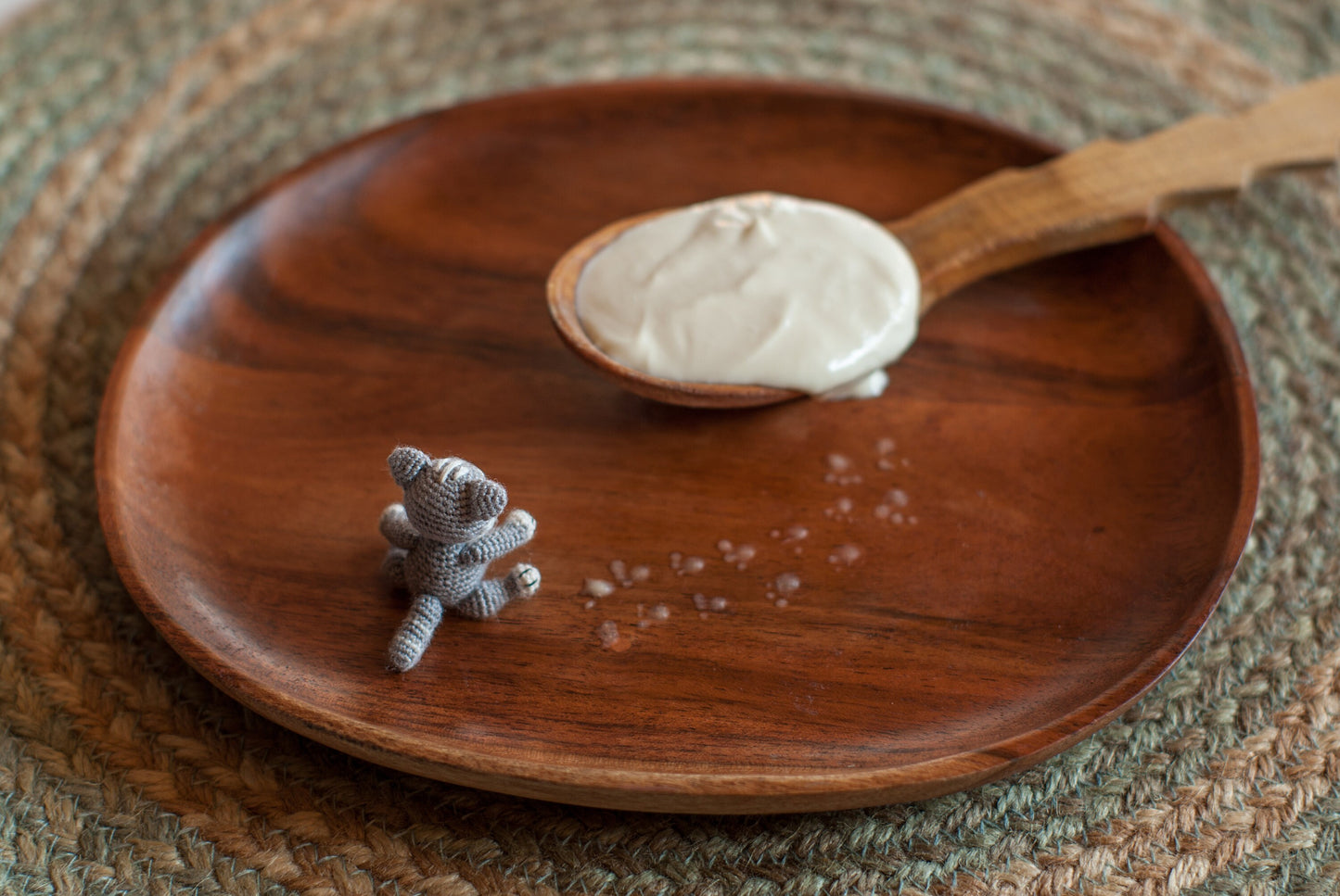 Miniature kitten with embroidered details in a cozy kitchen scene.