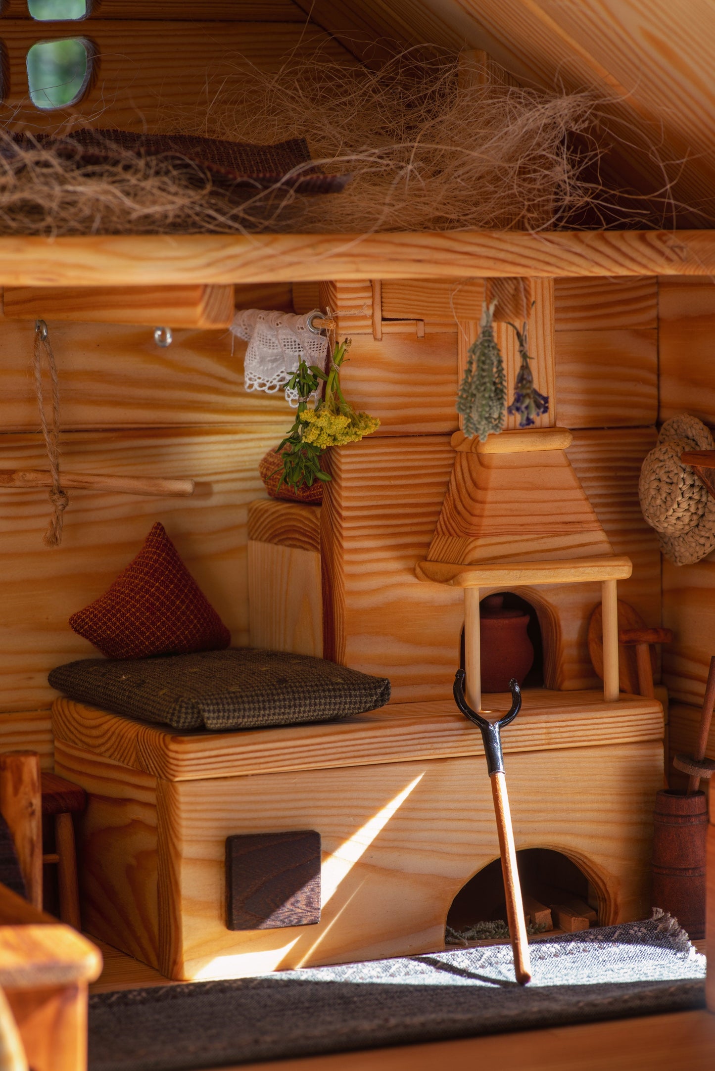 Cozy rustic stove and bench with herbs – Ukrainian dollhouse interior photo.