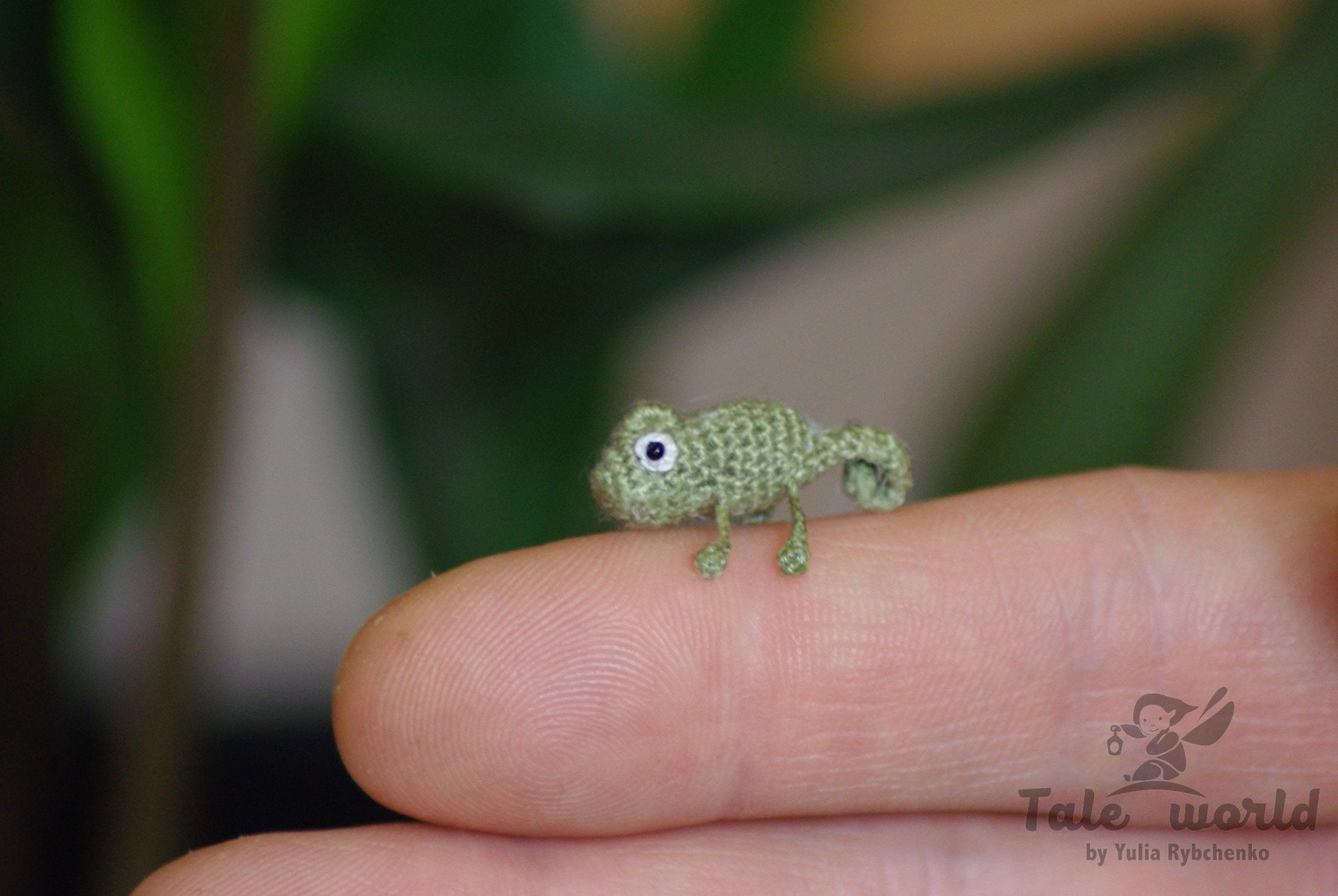 Tiny handmade green chameleon made of cotton threads