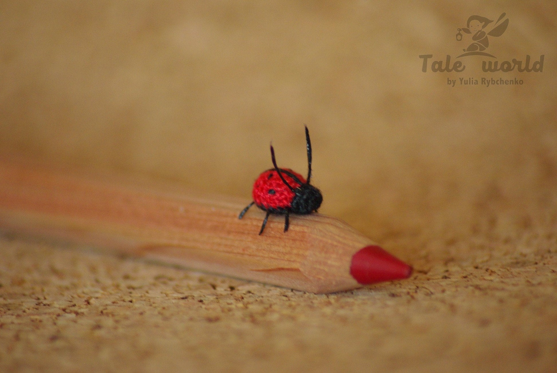 Amigurumi insect figurine on poetry pages