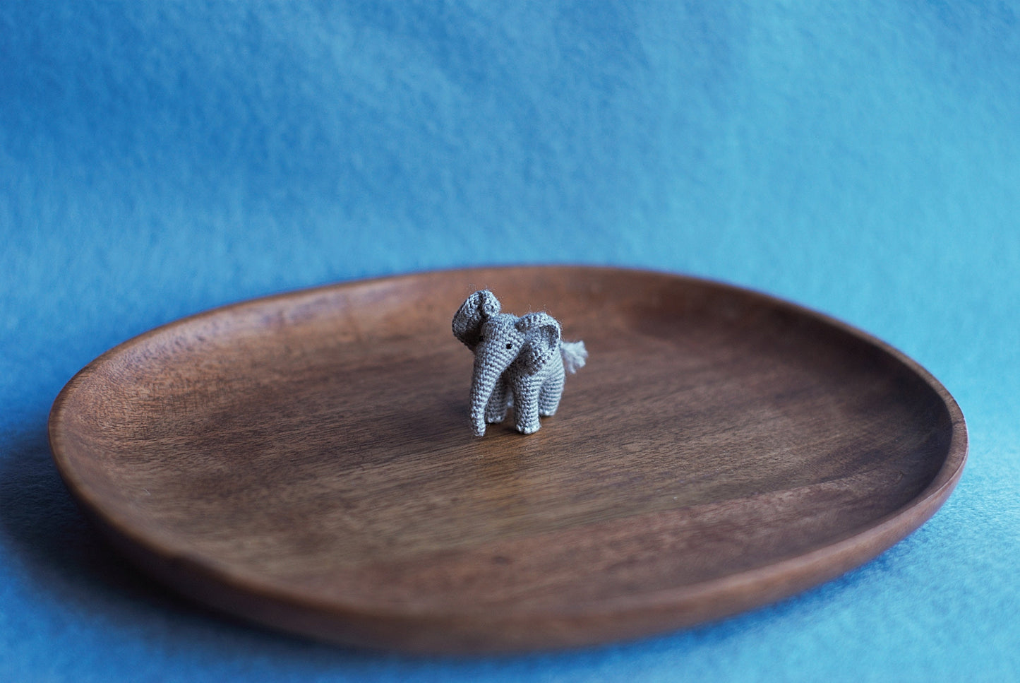 Miniature amigurumi elephant with long trunk and soft ears