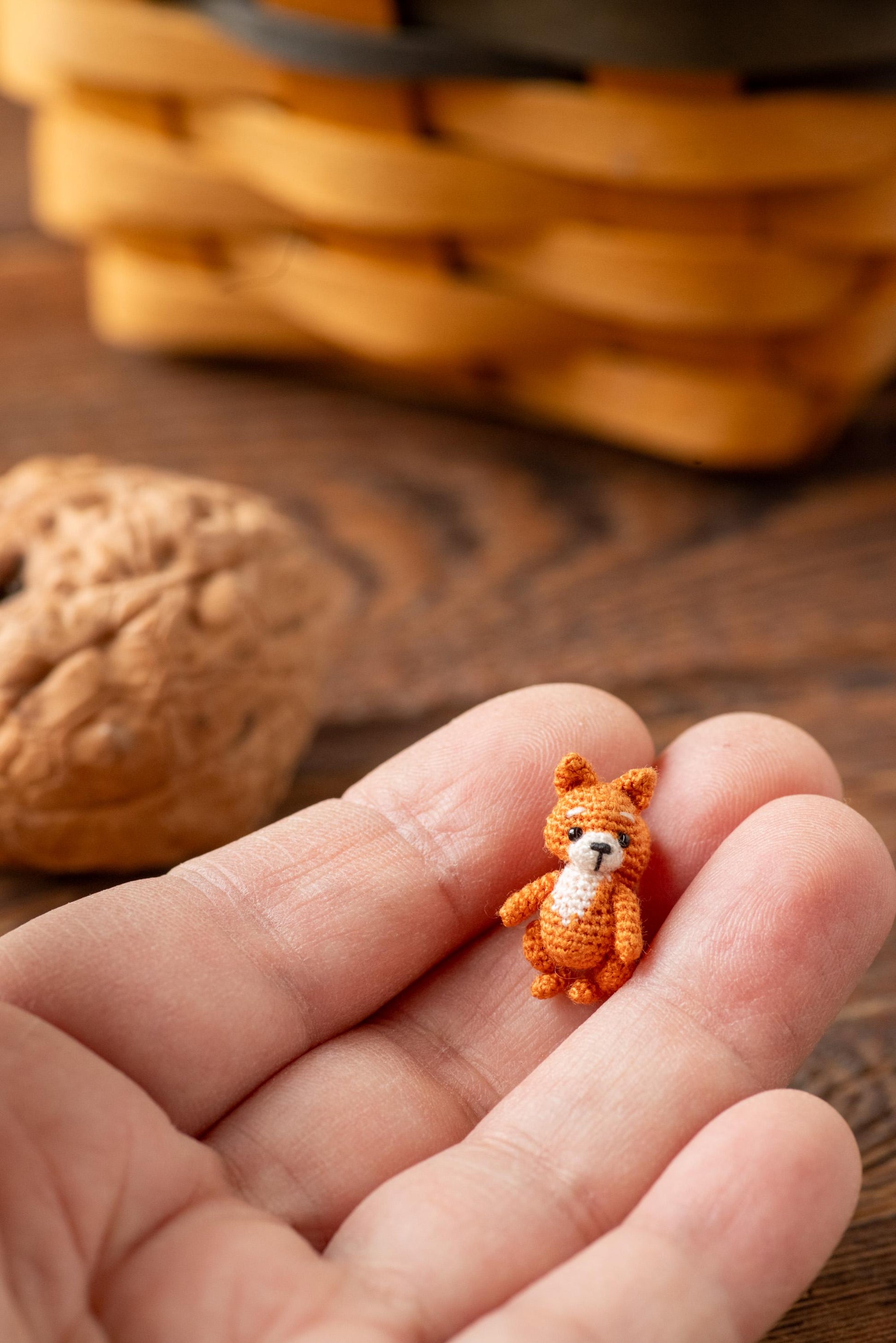 Tiny crochet squirrel in a human hand