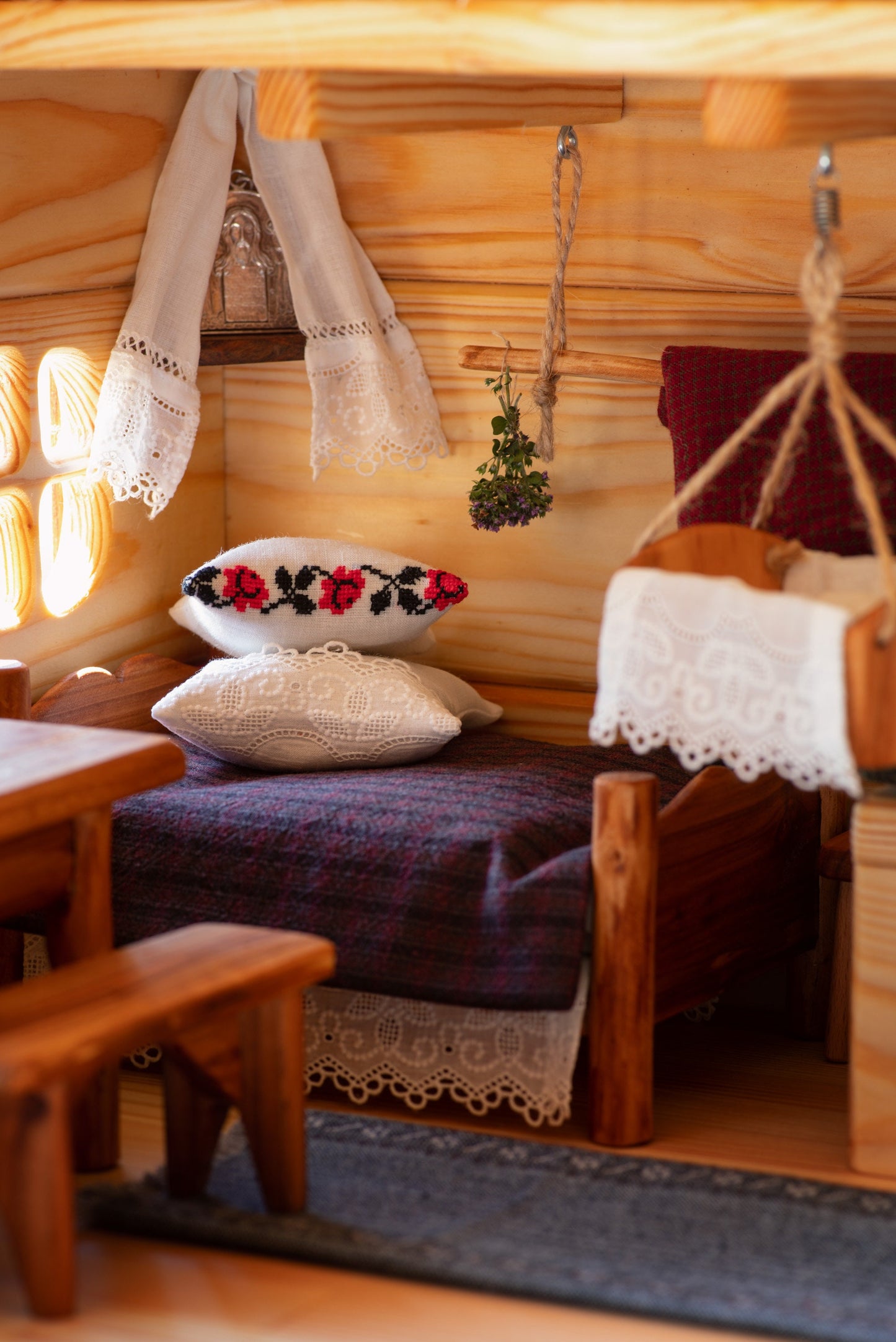 Rustic miniature Ukrainian bed with lace pillows and cradle – digital photo