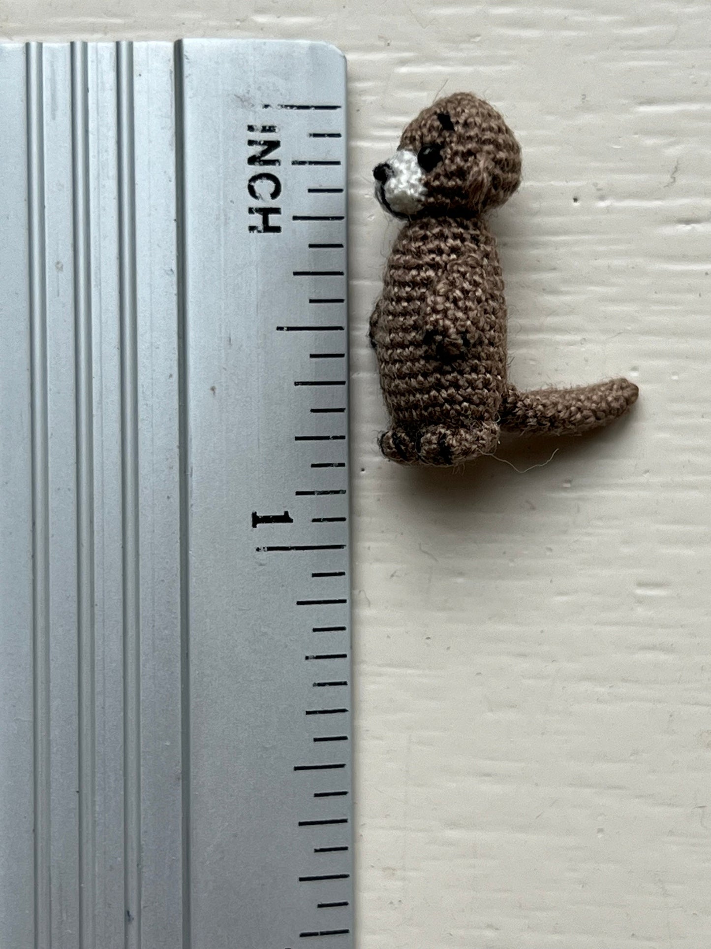 TaleWorld crochet otter with flexible tail ready for gentle posing