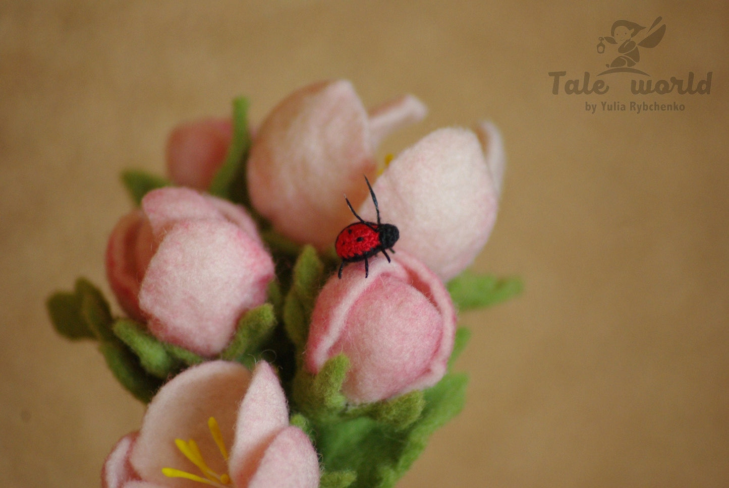 Small red and black crochet lady bug on flowers