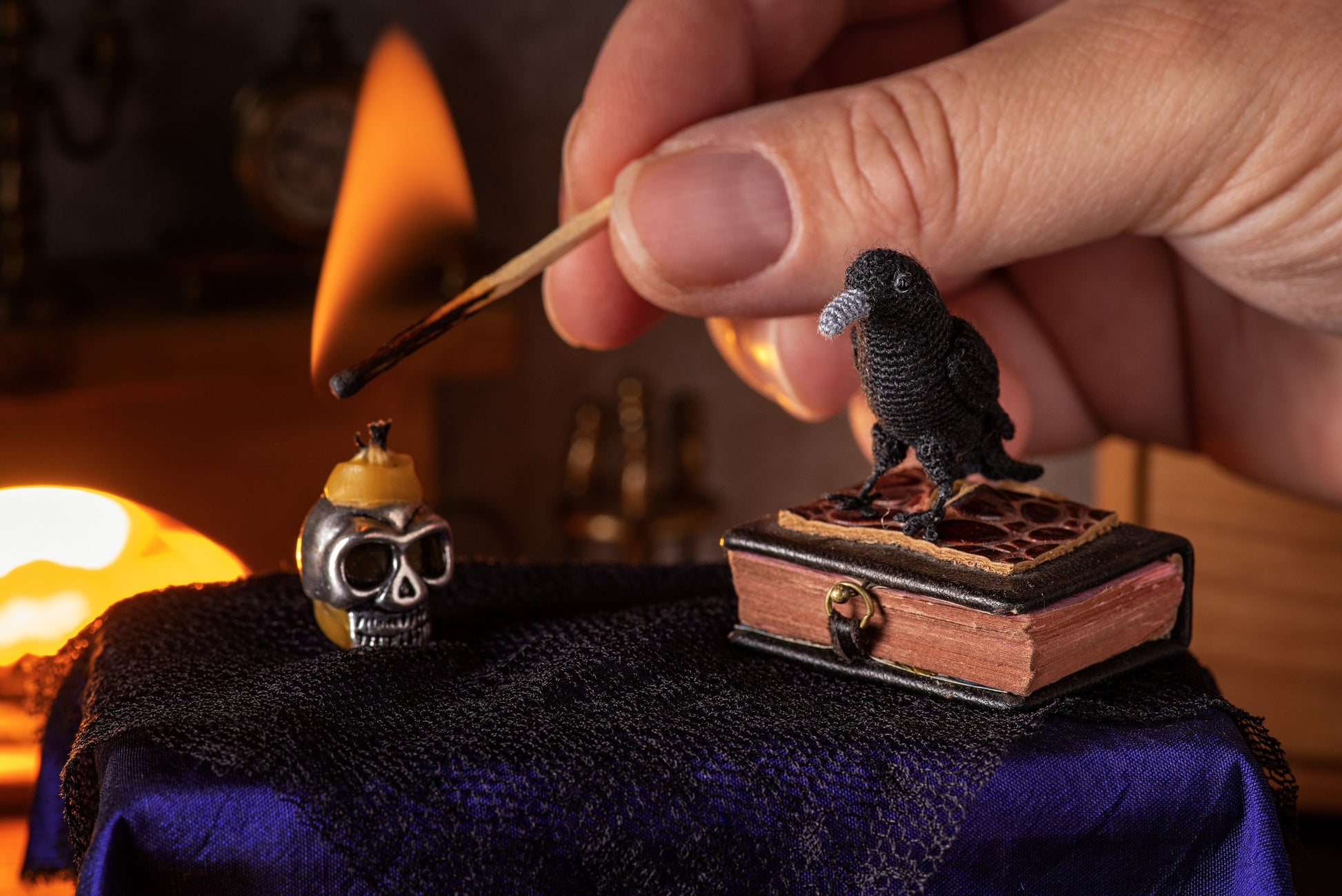 Tiny handmade black bird figurine styled with old clock and fireplace in dollhouse scene