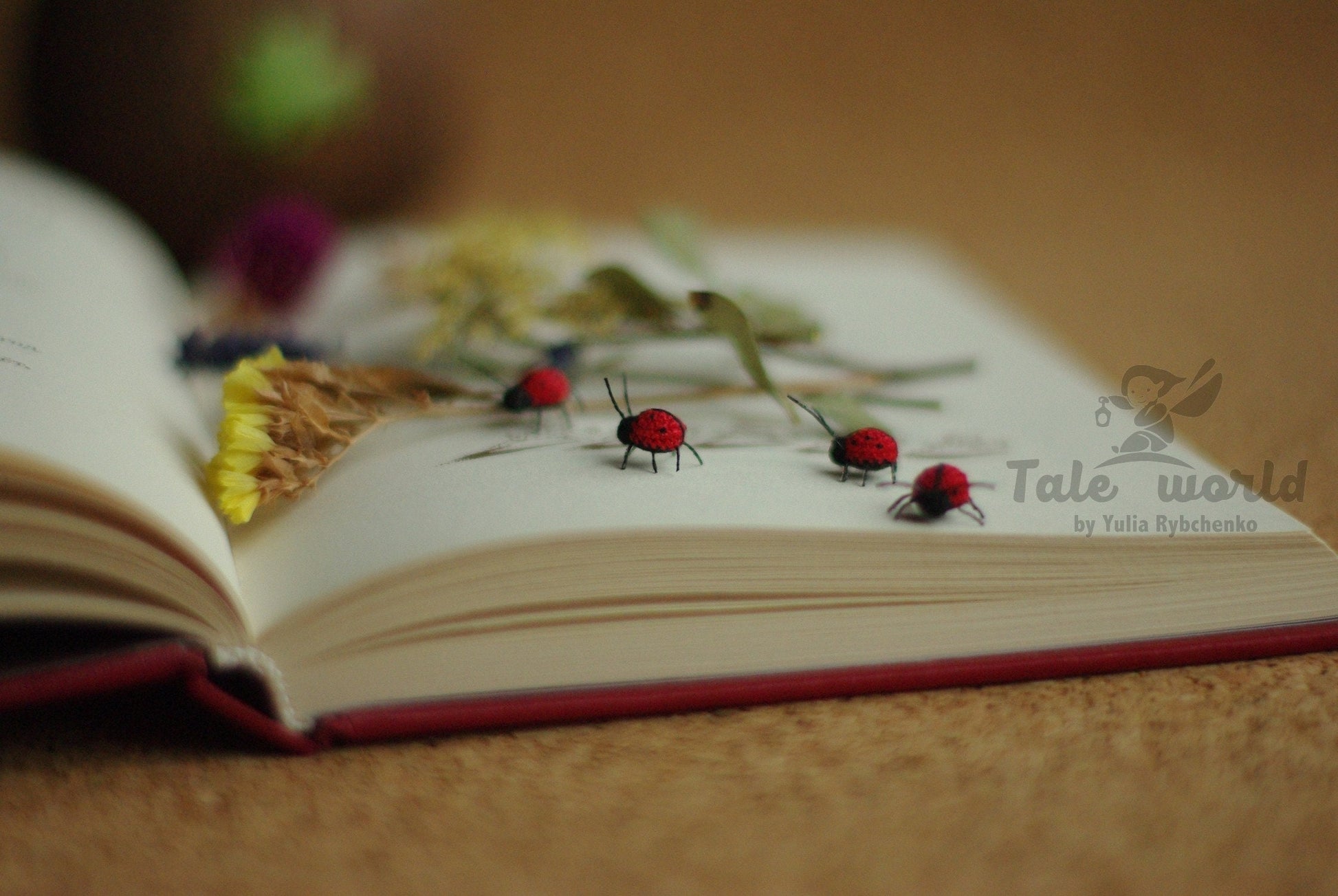 Tiny crochet ladybug walking across an open book