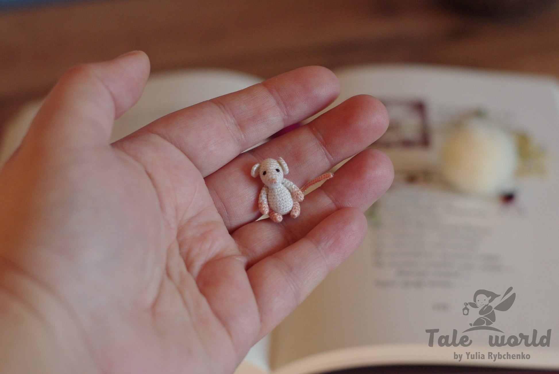 Miniature amigurumi rat figurine near poem