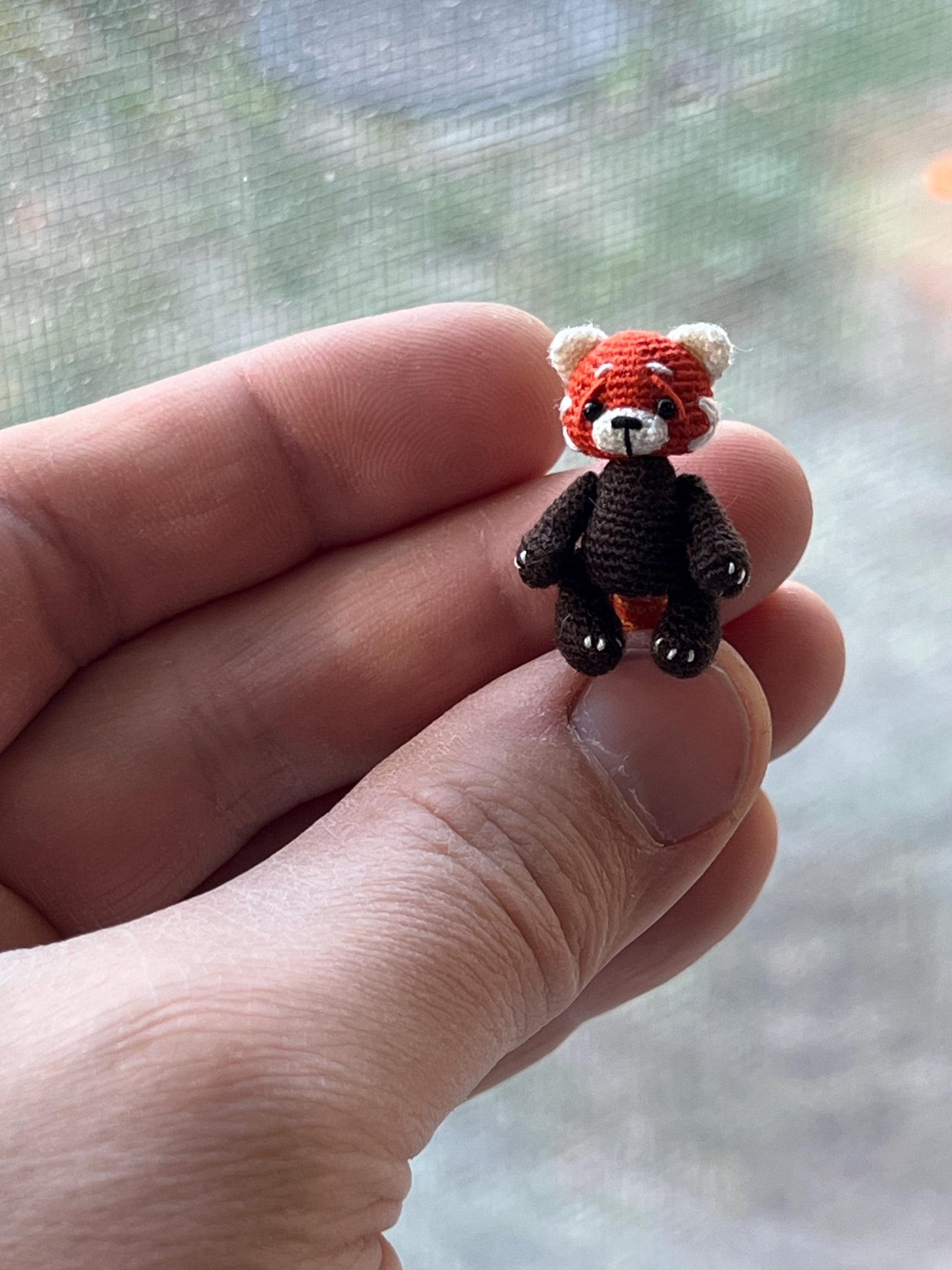 Small red panda figurine made of cotton threads