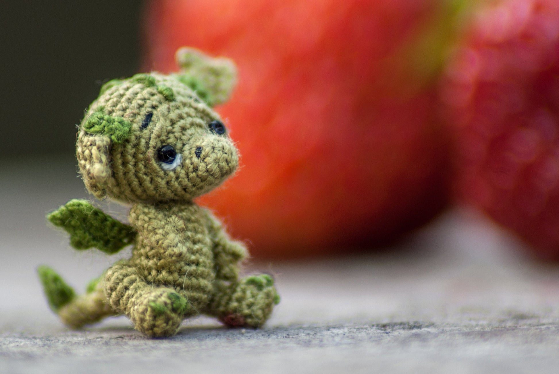 Tiny green crochet dragon figurine