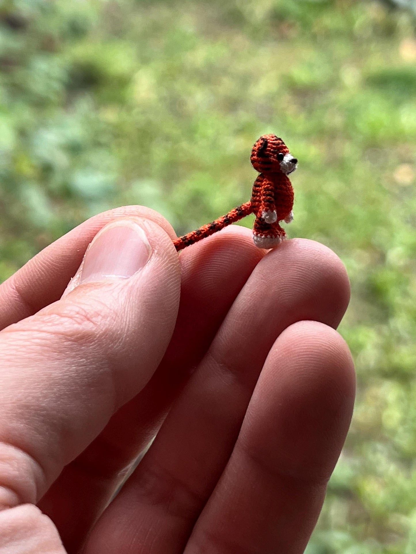 Close-up of micro crochet jungle tiger with soft features and bright color