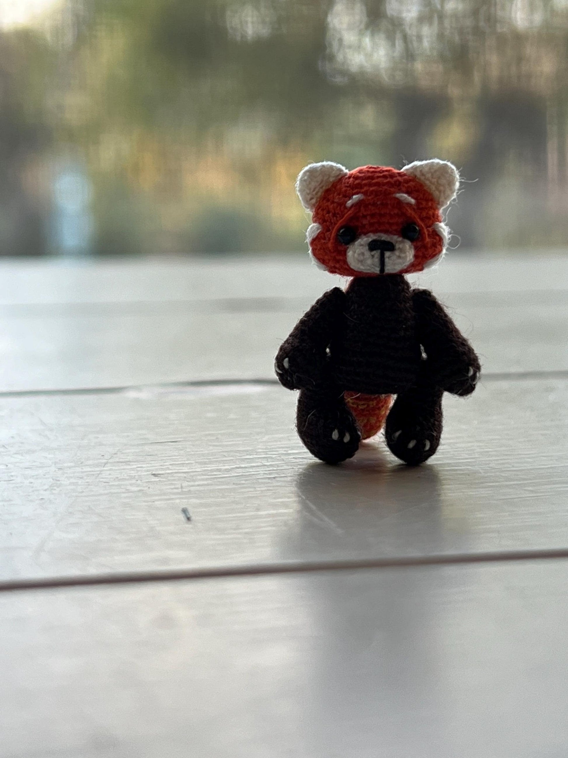 Close-up of mini red panda toy with delicate features