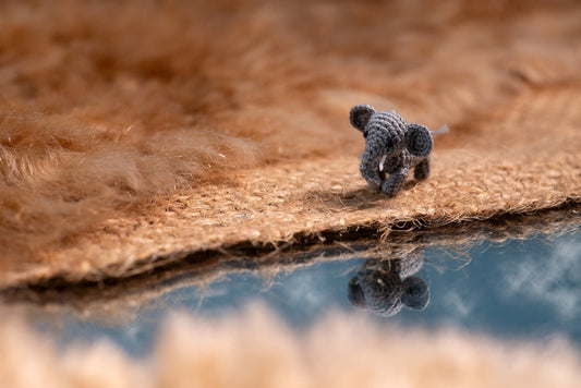Miniature amigurumi elephant walking toward a river