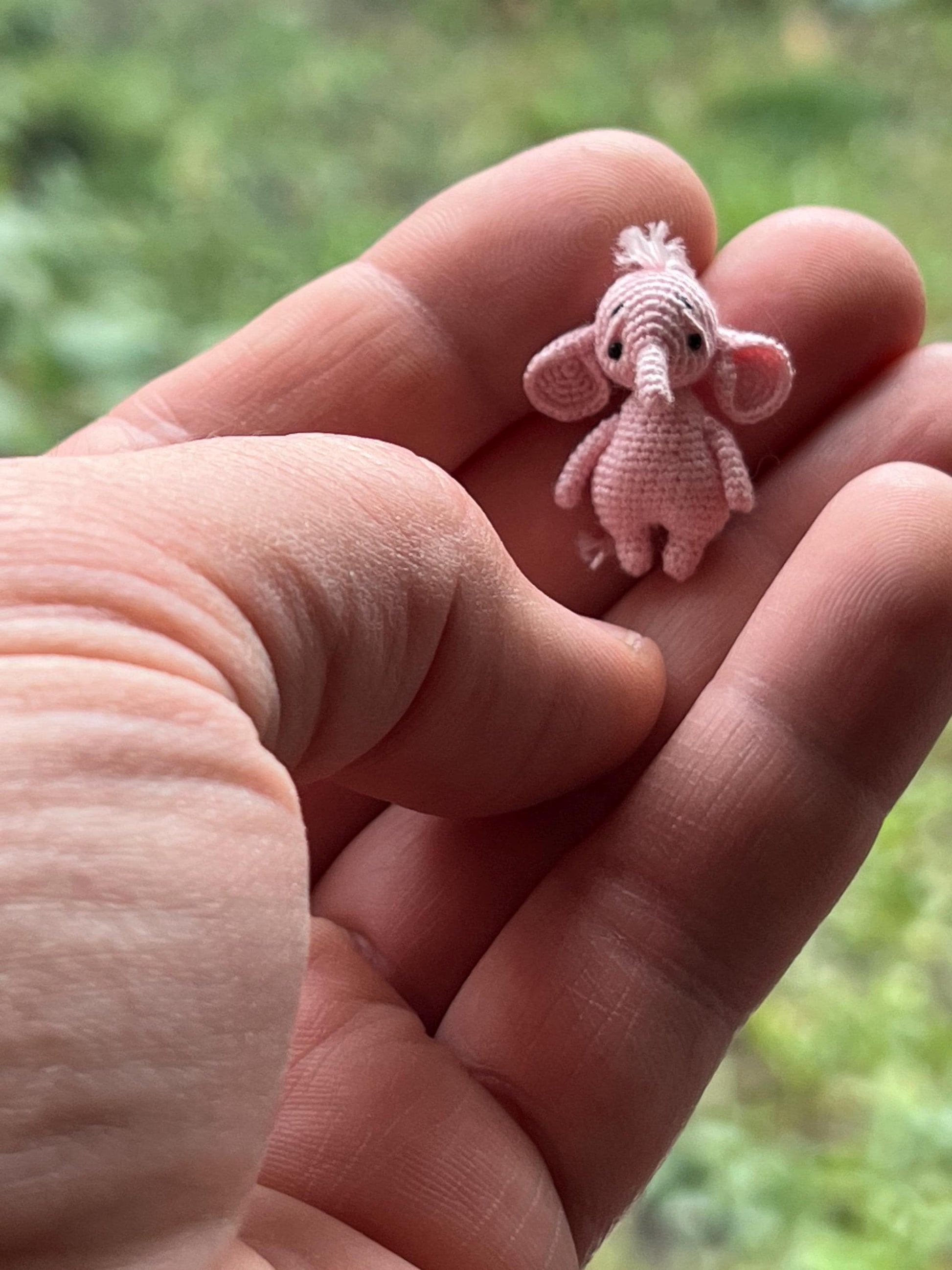 Sweet crochet elephant surrounded by fluffy treats