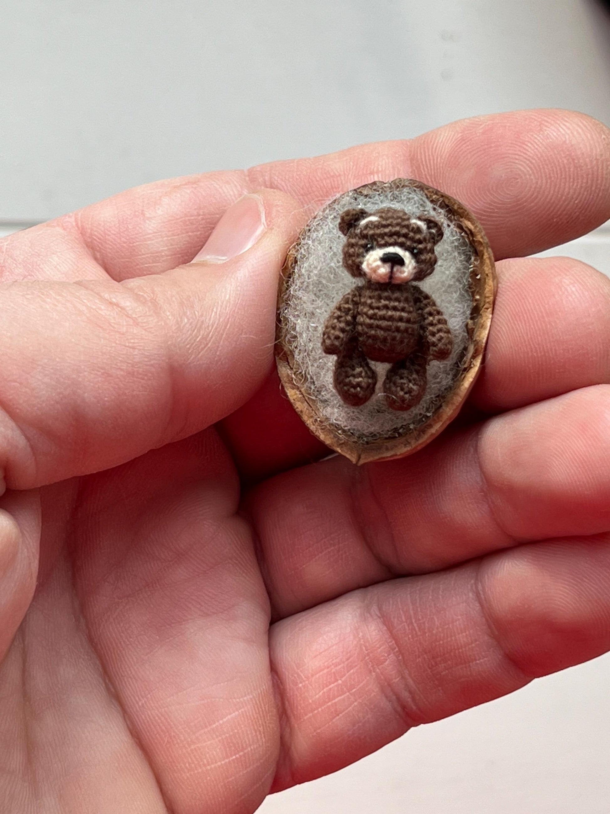 Handmade brown bear figurine next to chocolate blocks and coffee beans