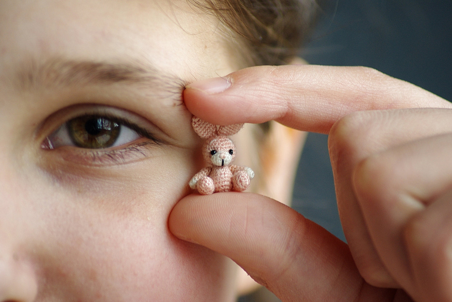Miniature handmade amigurumi rabbit with floppy ears