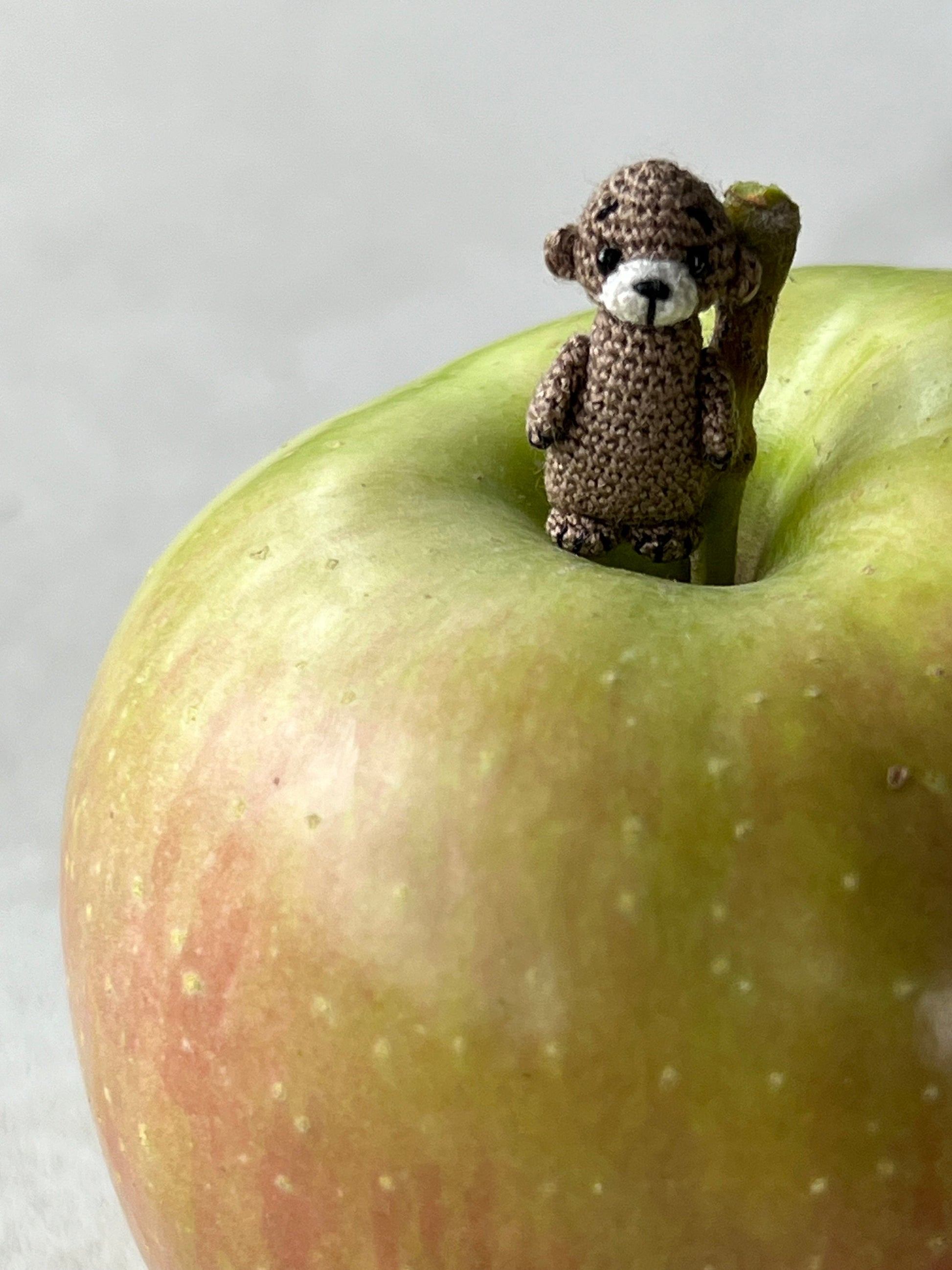 Otter doll surrounded by pebbles and magic — tiny, expressive, and sweet