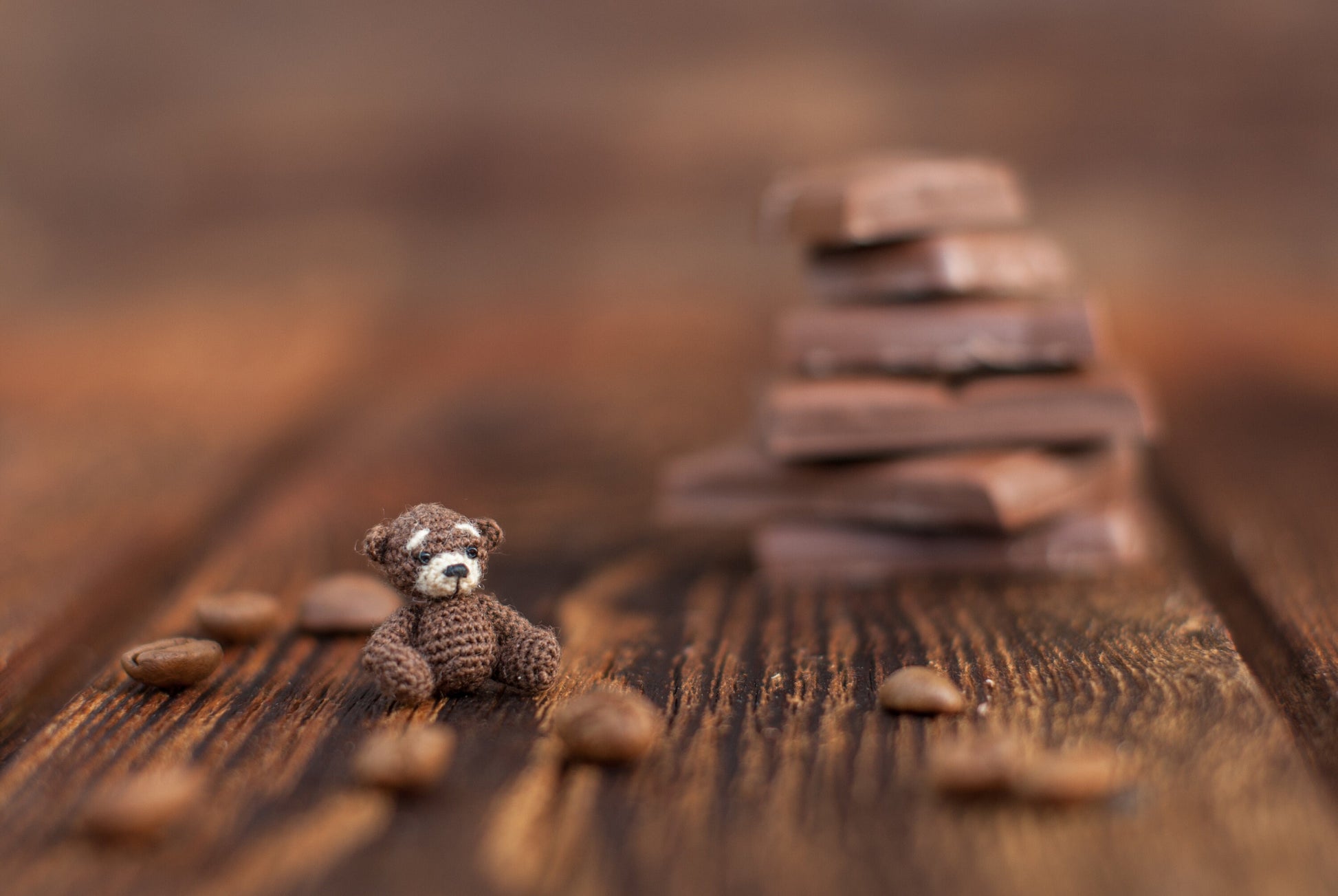 Miniature amigurumi teddy bear with deep gaze and stitched details