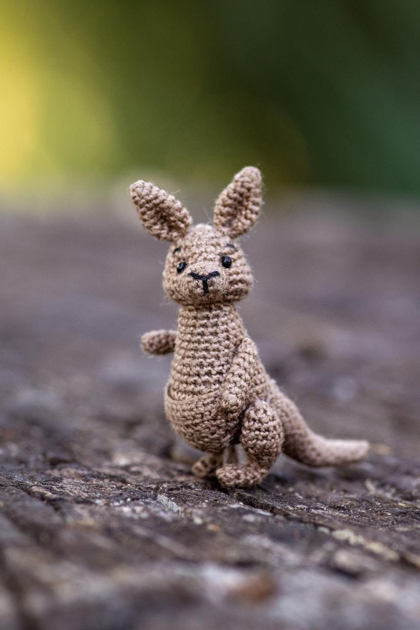 Tiny kangaroo toy in natural outdoor setting
