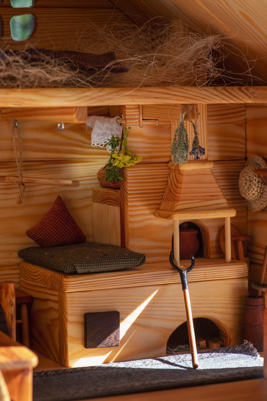 Cozy rustic stove and bench with herbs – Ukrainian dollhouse interior photo.