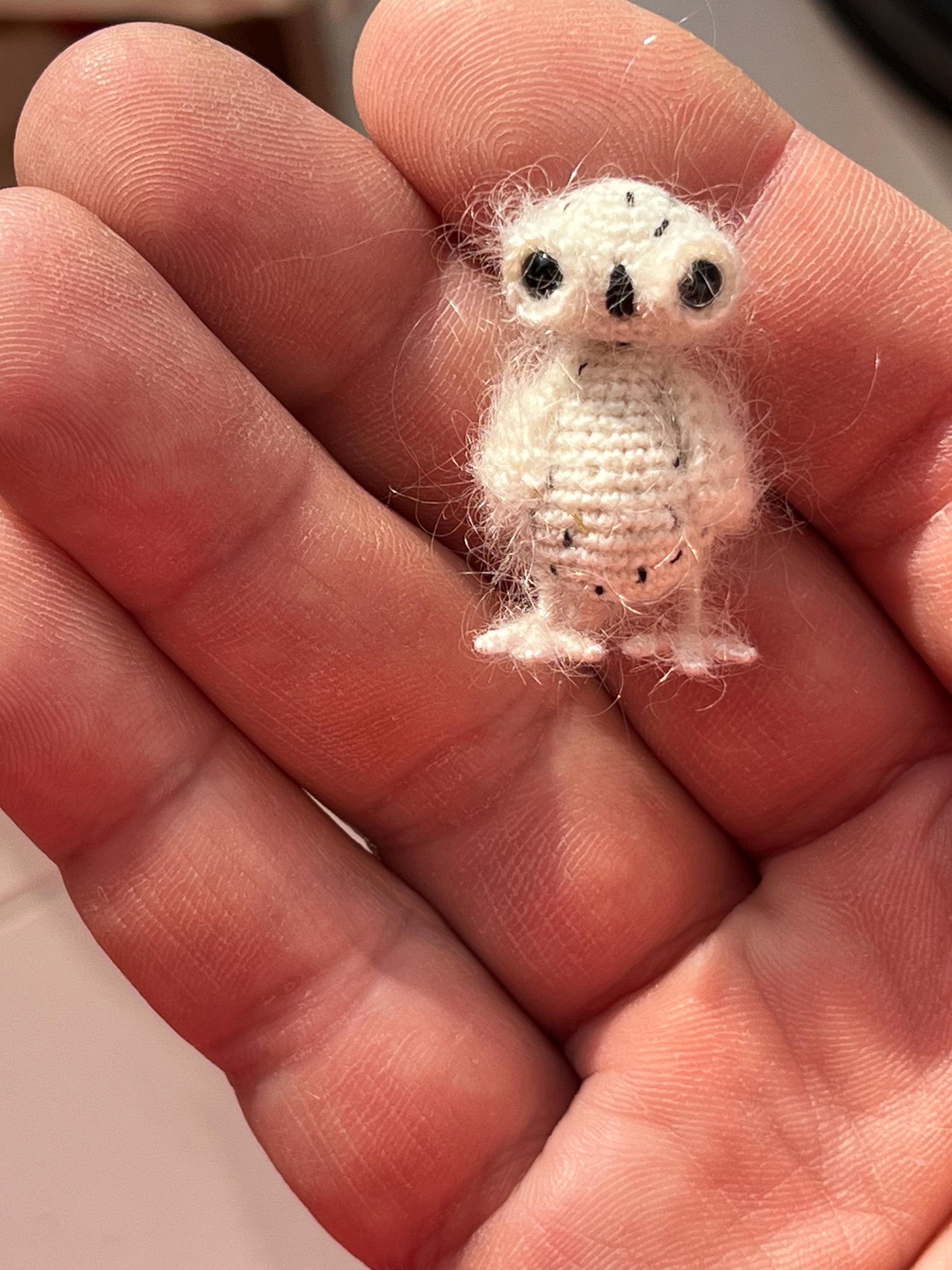 Handmade white owl bird resting in hand