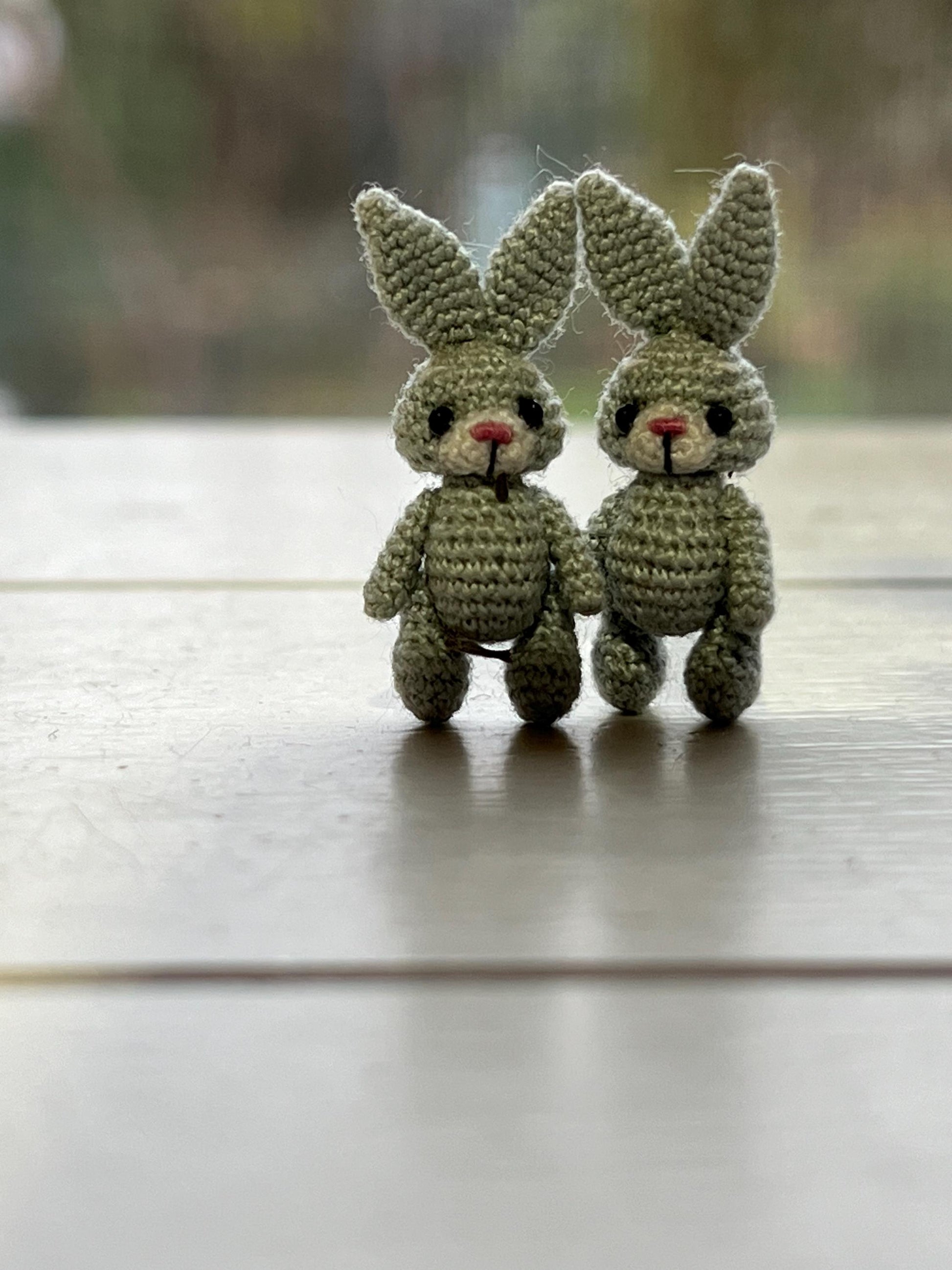 Close-up of pocket-sized grey crochet rabbit for dollhouse or collectible play