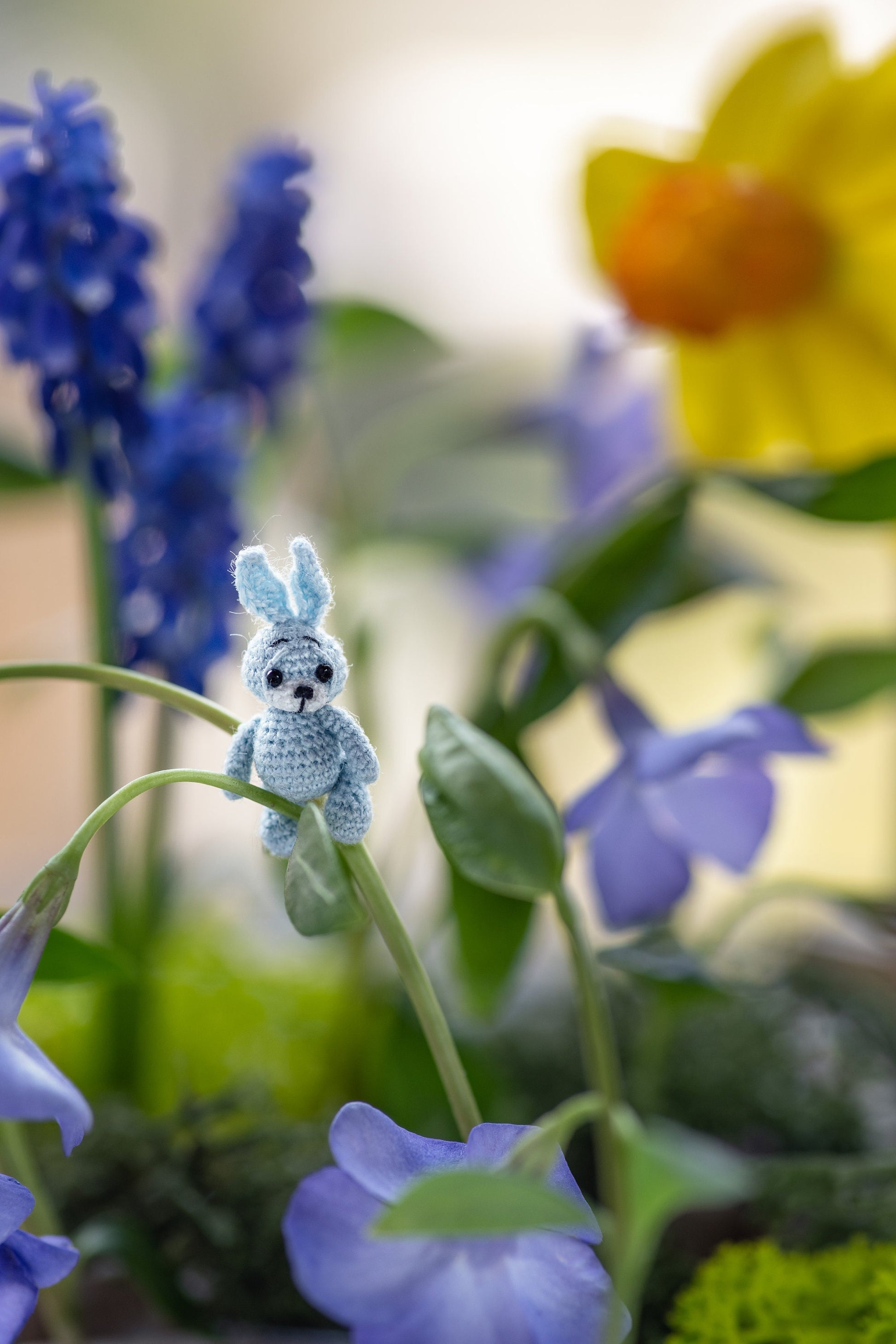 Handmade miniature rabbit with long ears in soft storytelling scene