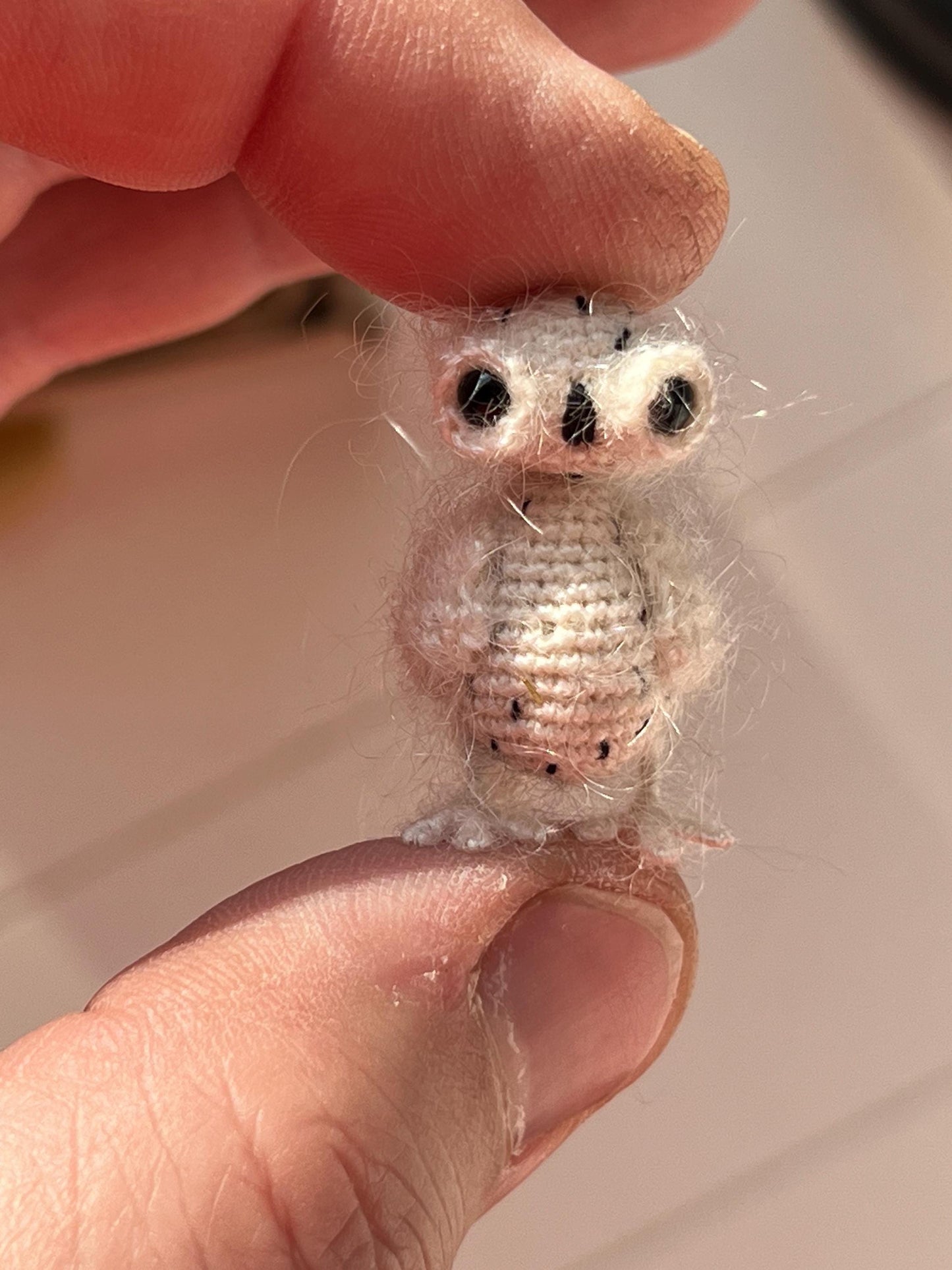 Miniature amigurumi owl with fluffy details