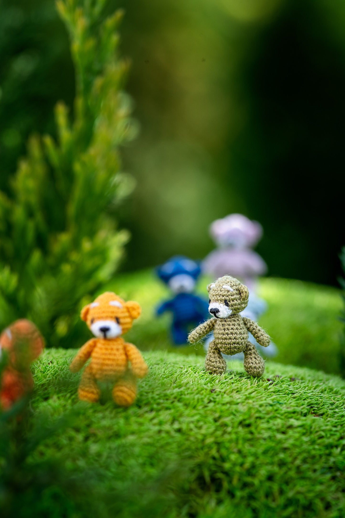Micro crochet teddy bears in playful woodland scene